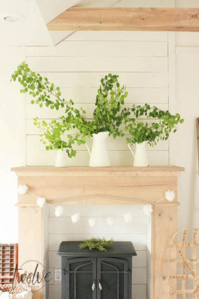 faux fireplace with wood burning stove against a shiplap wall