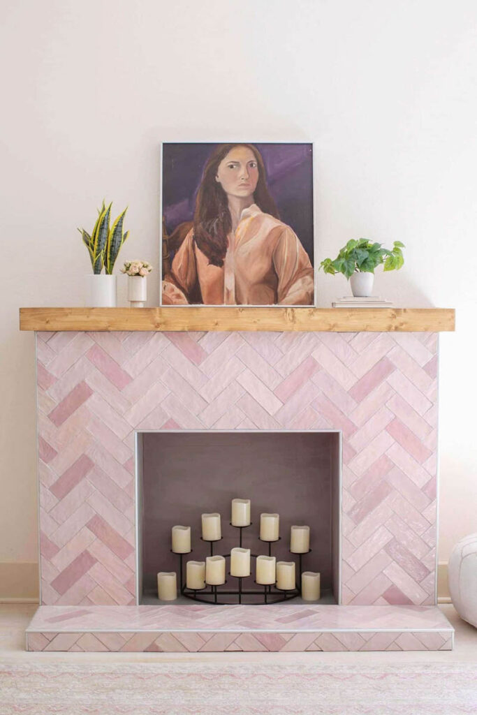 pink herringbone tiled faux fireplace with wood mantle