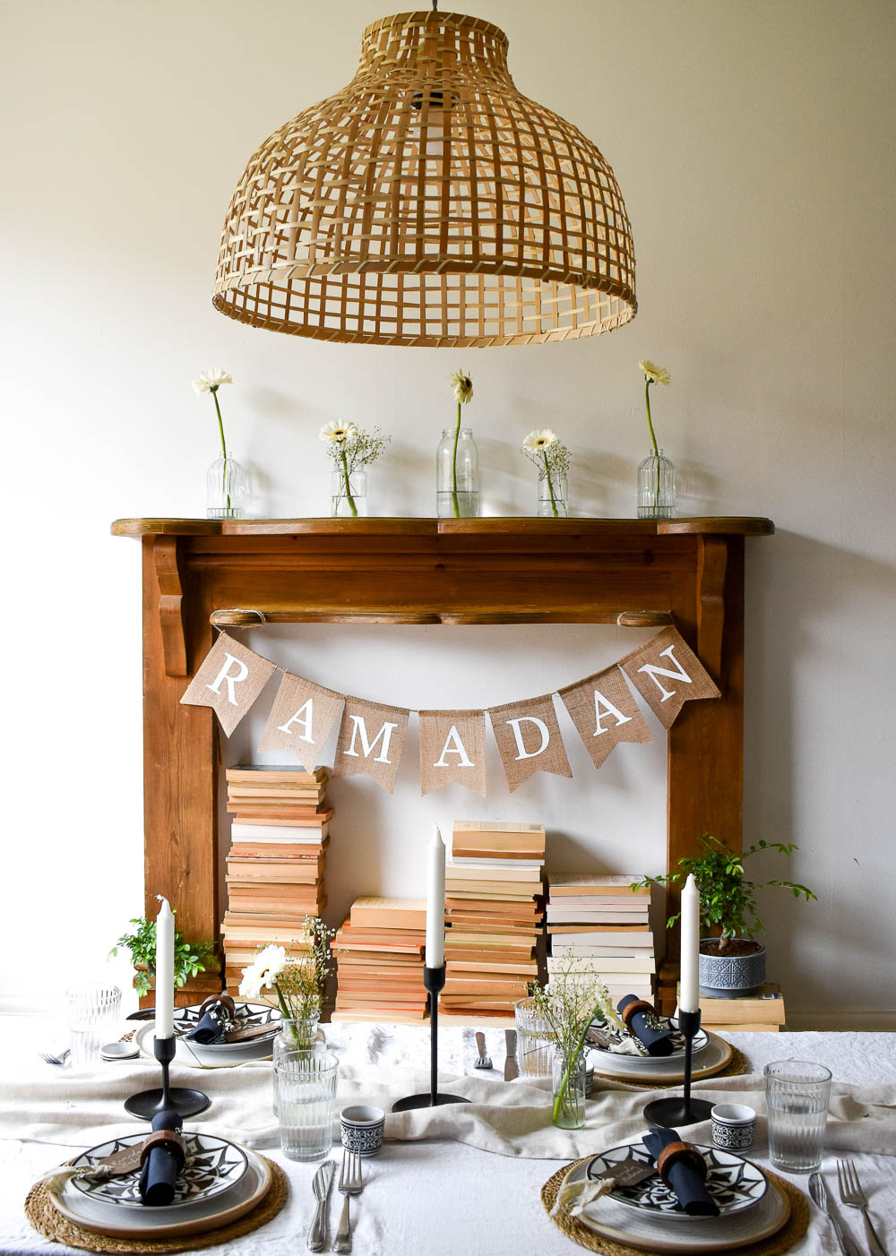 faux fireplace behind dining table with Ramadan banner