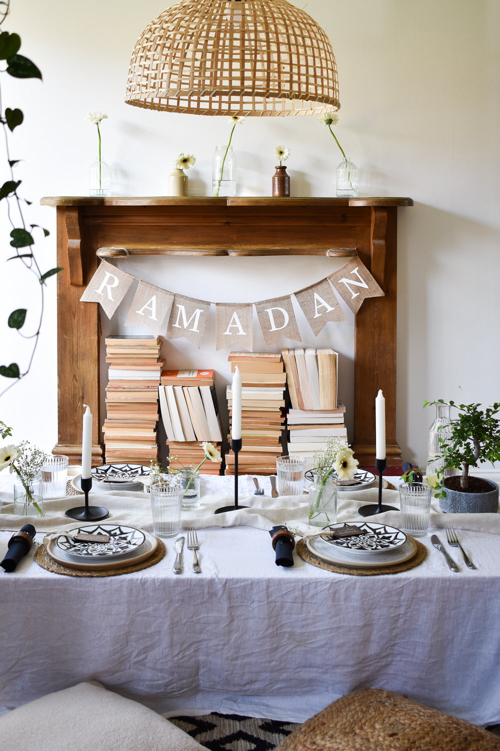 Ramadan tablescape with faux fireplace behind it with Ramadan banner.